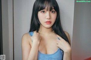 A woman in a white lingerie posing for a picture.