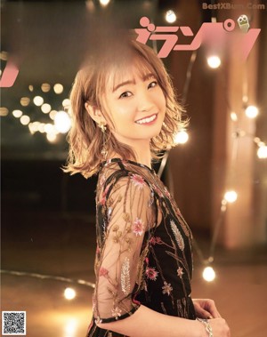 A magazine page with a picture of a woman in a dress.