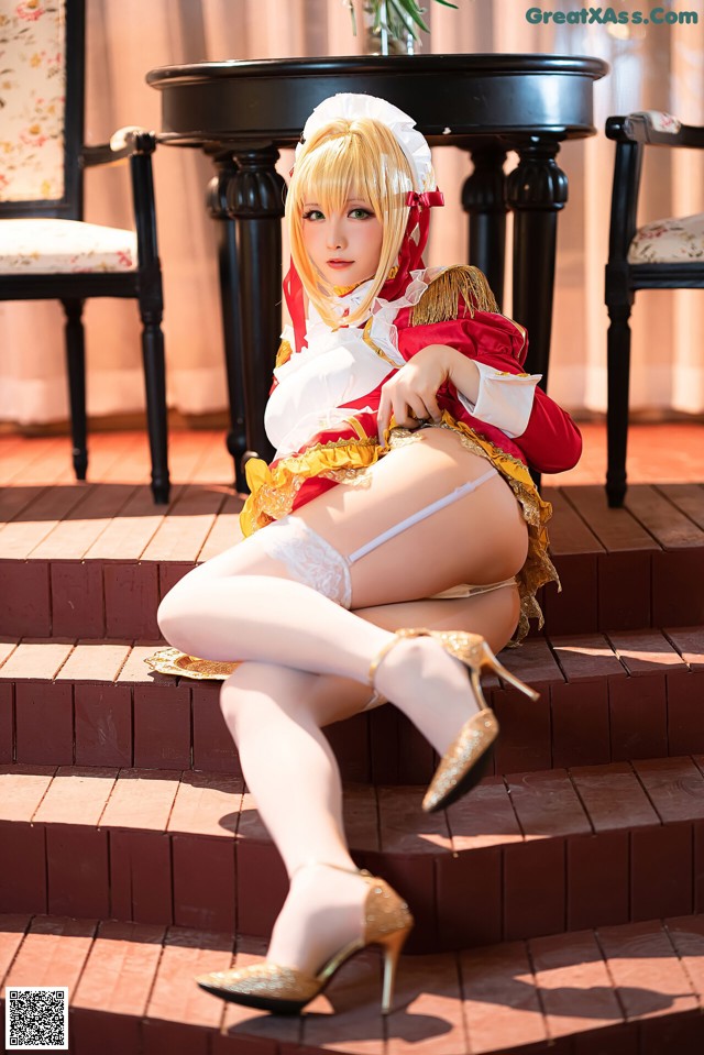 A woman in a maid outfit sitting on some steps.