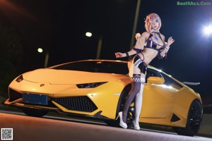 A woman sitting in the back of a yellow car.