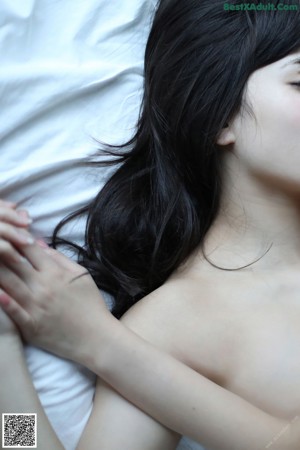 A woman in a white bra and panties is posing for the camera.
