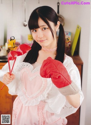 A woman holding a bowl of rice in a kitchen.