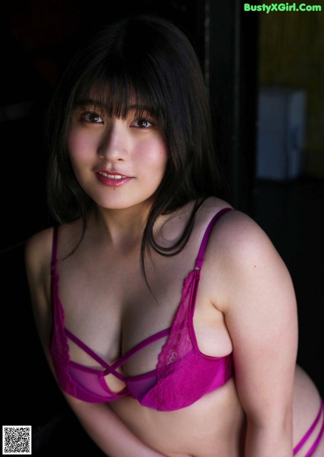 A woman in a pink bra and panties posing for a picture.